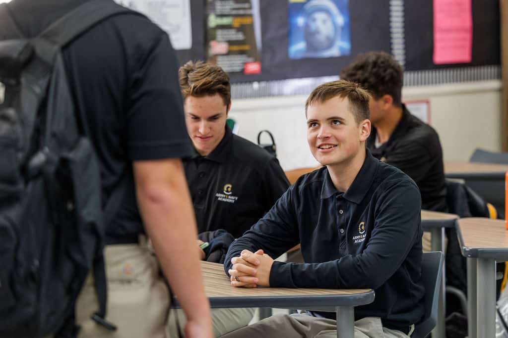 students in black shirts are in a classroom