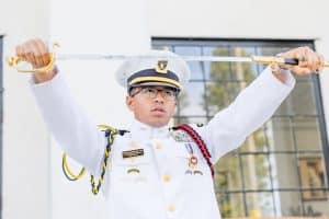 student holding a ceremonial sword