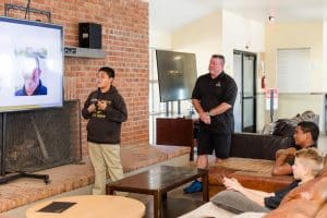 student giving a presentation in a lounge setting