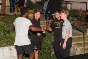 Students enjoying a lively outdoor gathering in the evening.