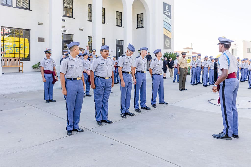 A group of uniformed cadets standing in a straight line