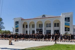 students lined up outside a building