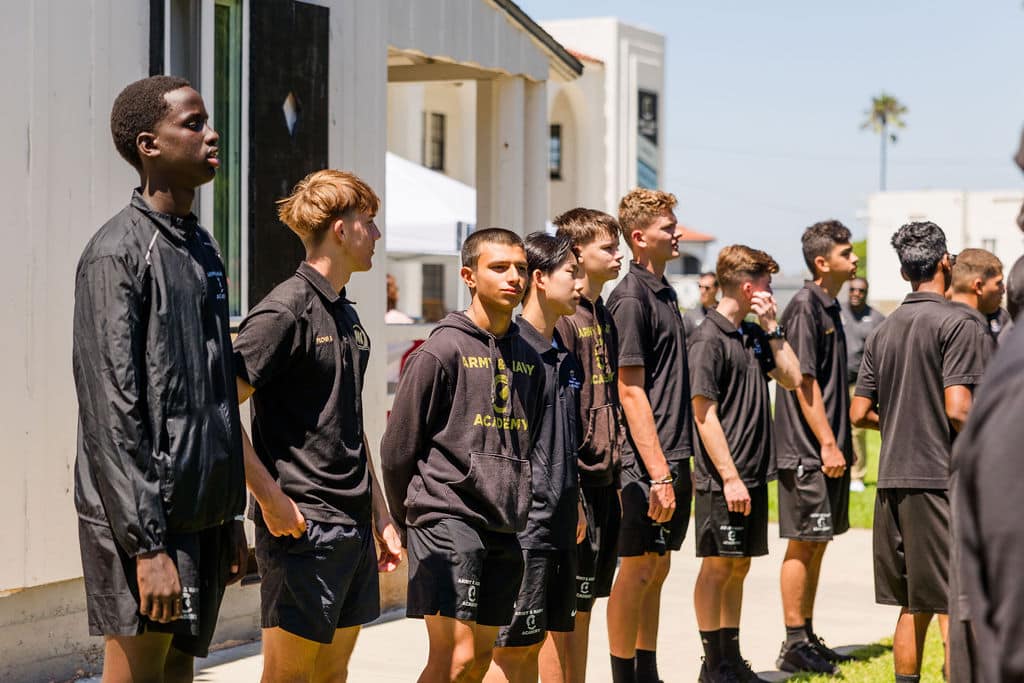 group of young students wearing black shirts stands in a line