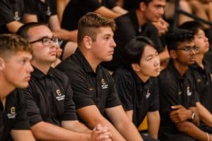 Students attentively listening during a college school orientation