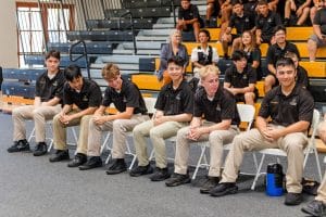 Students seated and smiling during a school assembly