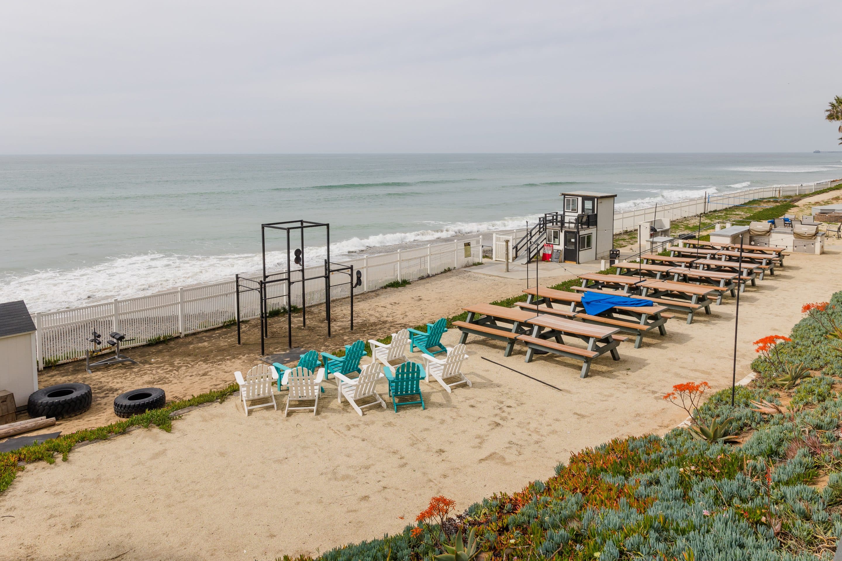 Beachfront recreation hall, outdoor living space with BBQ, fire pit, and cross fit gym